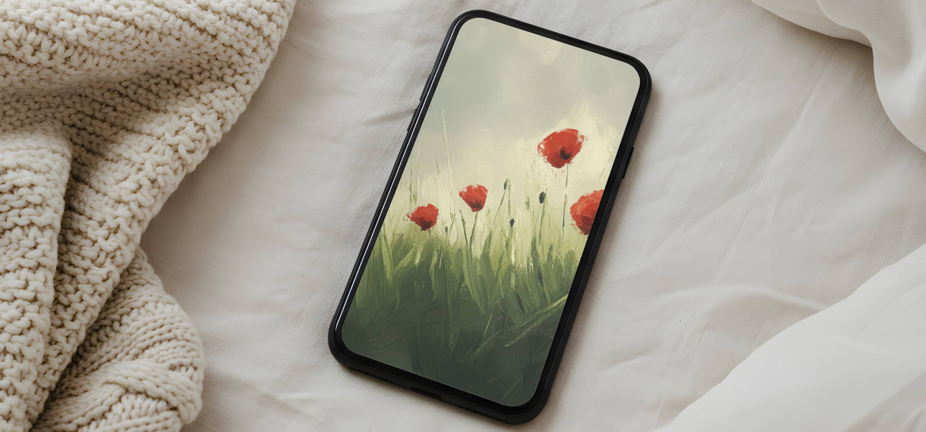 Soft floral iPhone wallpaper featuring red poppies in a painterly green field, displayed in a calm, minimalist bedroom setting.
