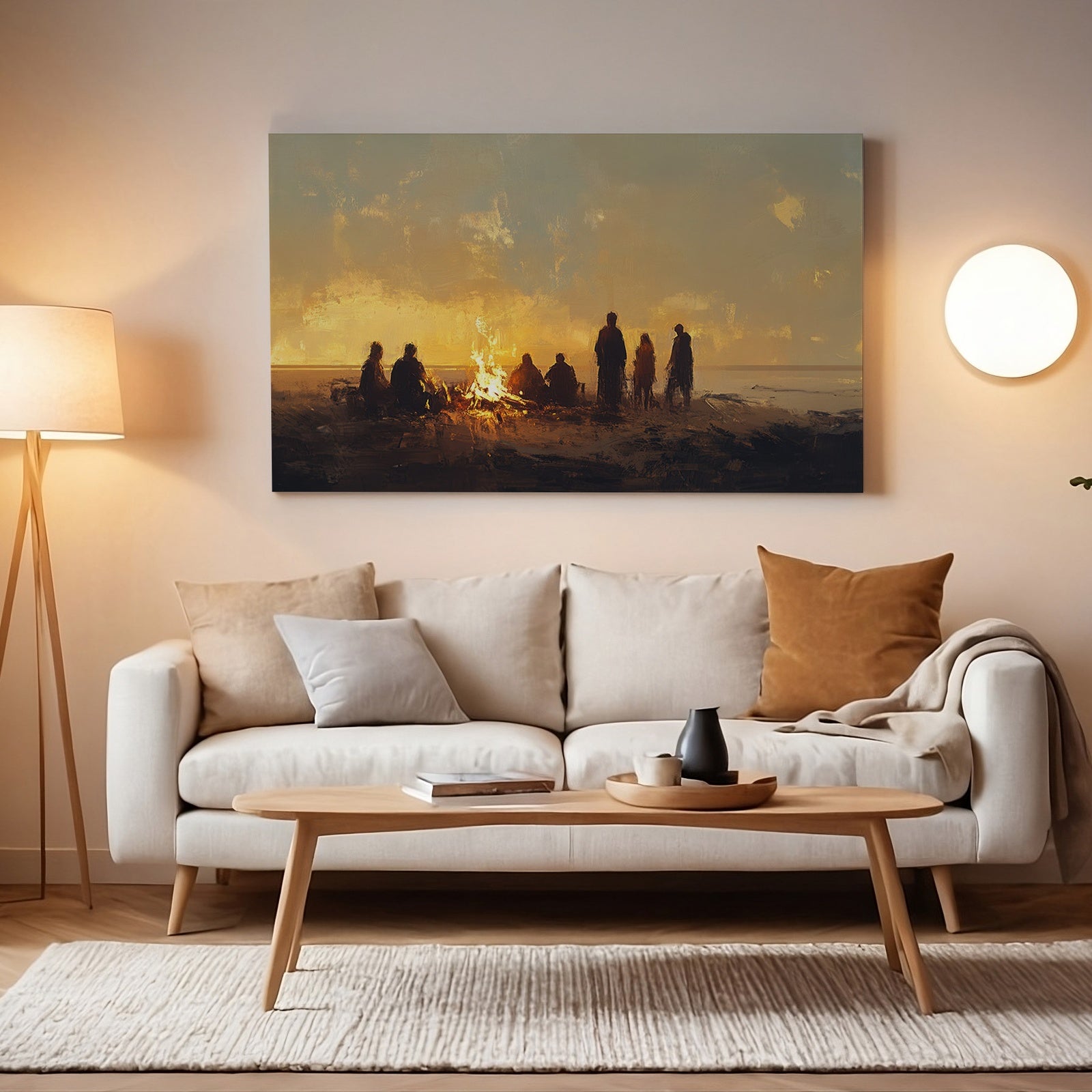 Cozy living room with warm lighting featuring a beach digital art print above the sofa, depicting a group of people sitting around a campfire at sunset, evoking relaxation and coastal serenity