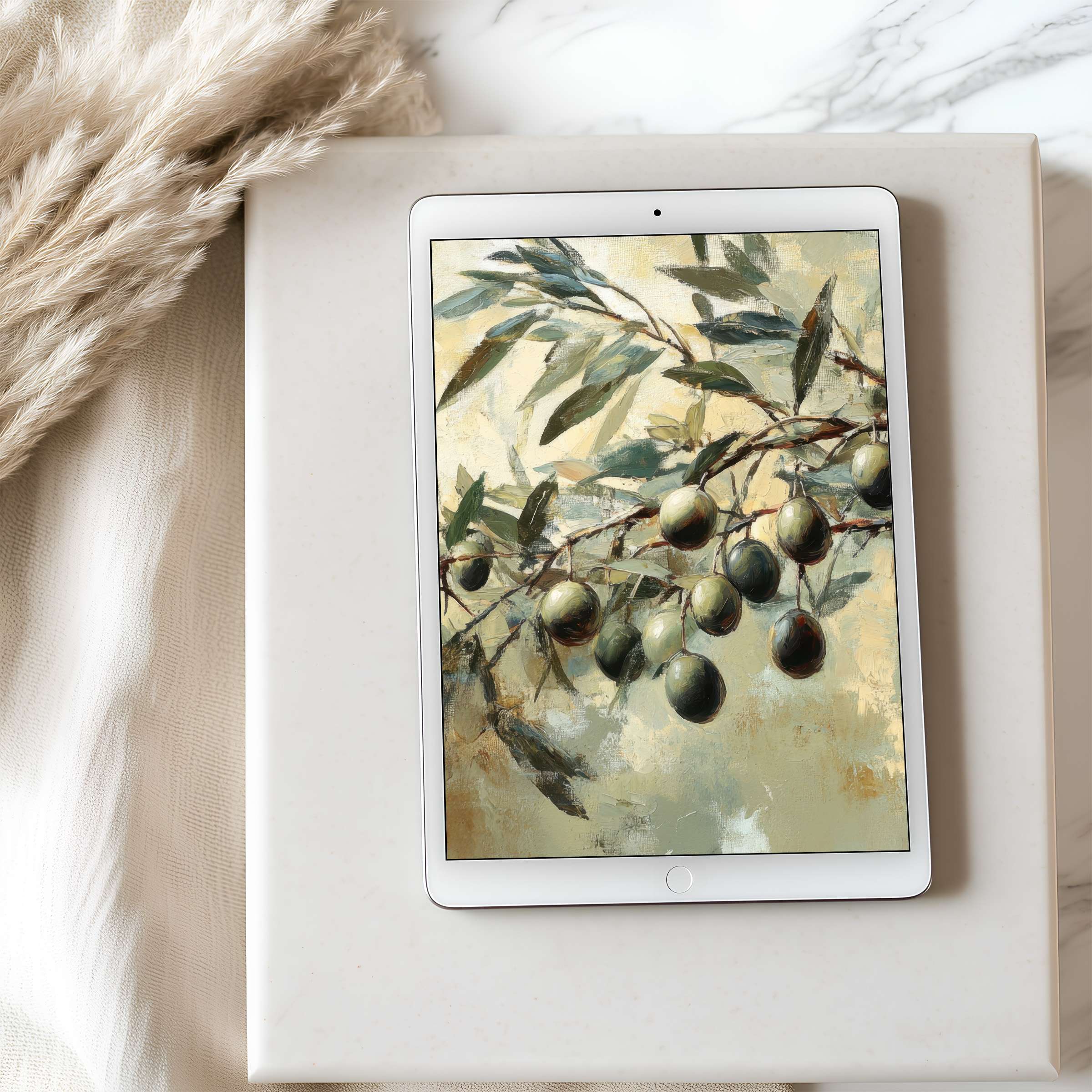 Elegant olive branch painting as tablet wallpaper on iPad set atop a soft fabric inviting serenity in high resolution download