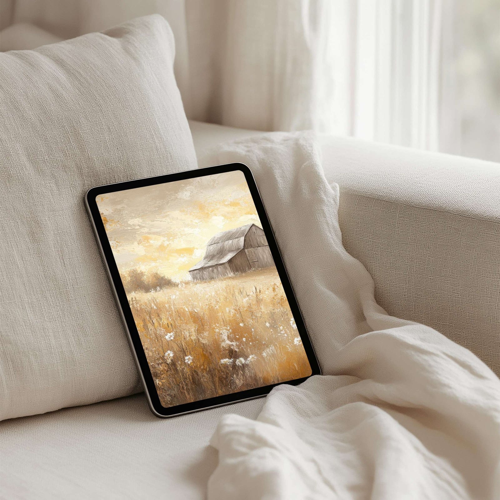 Farmhouse iPad wallpaper featuring a rustic barn in a sunlit golden meadow. A warm and calming digital background that brings cozy countryside charm, serenity and natural beauty to your tablet screen