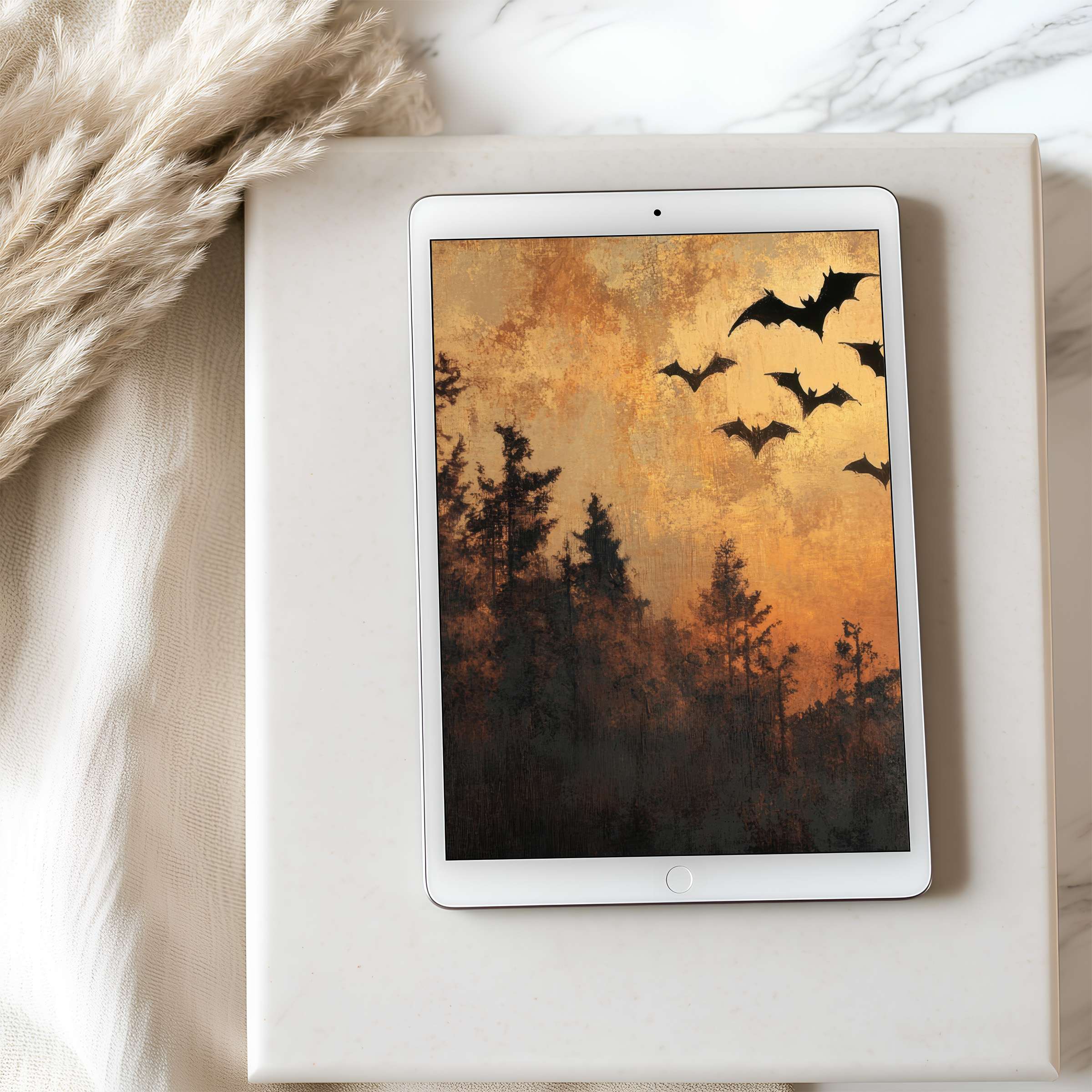 Elegant tablet wallpaper showcasing a serene forest silhouette and flying bats against a golden dusk sky suitable for iPad download