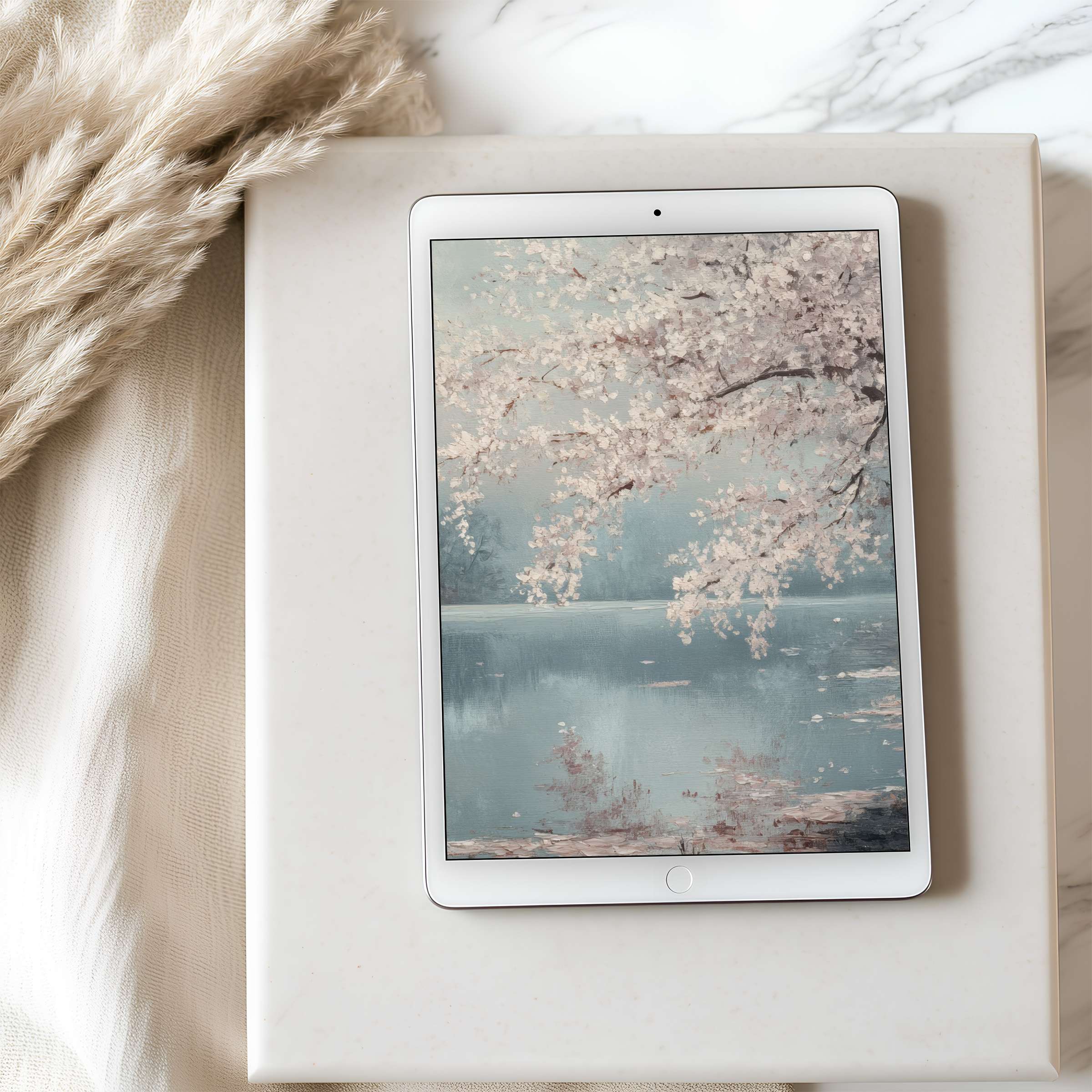 Elegant cherry blossom tablet wallpaper in serene pastel tones set on a marble surface ideal for iPad and Android tablets download