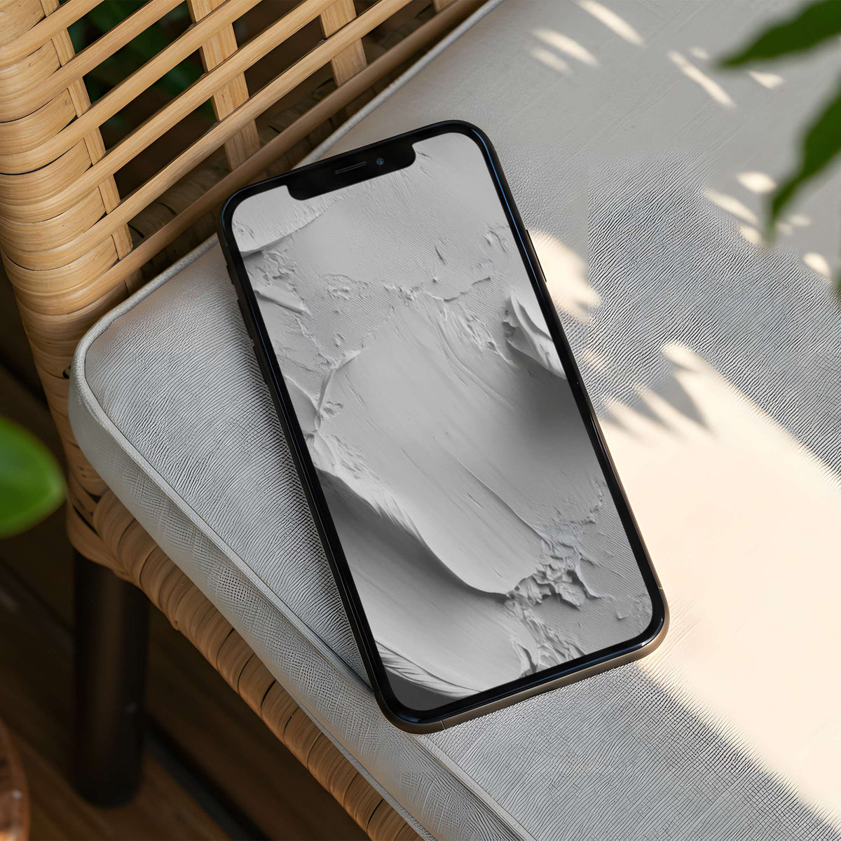 Elegant, textured grey iPhone background on a phone resting on rattan chair inspires calm and mindfulness with instant download option
