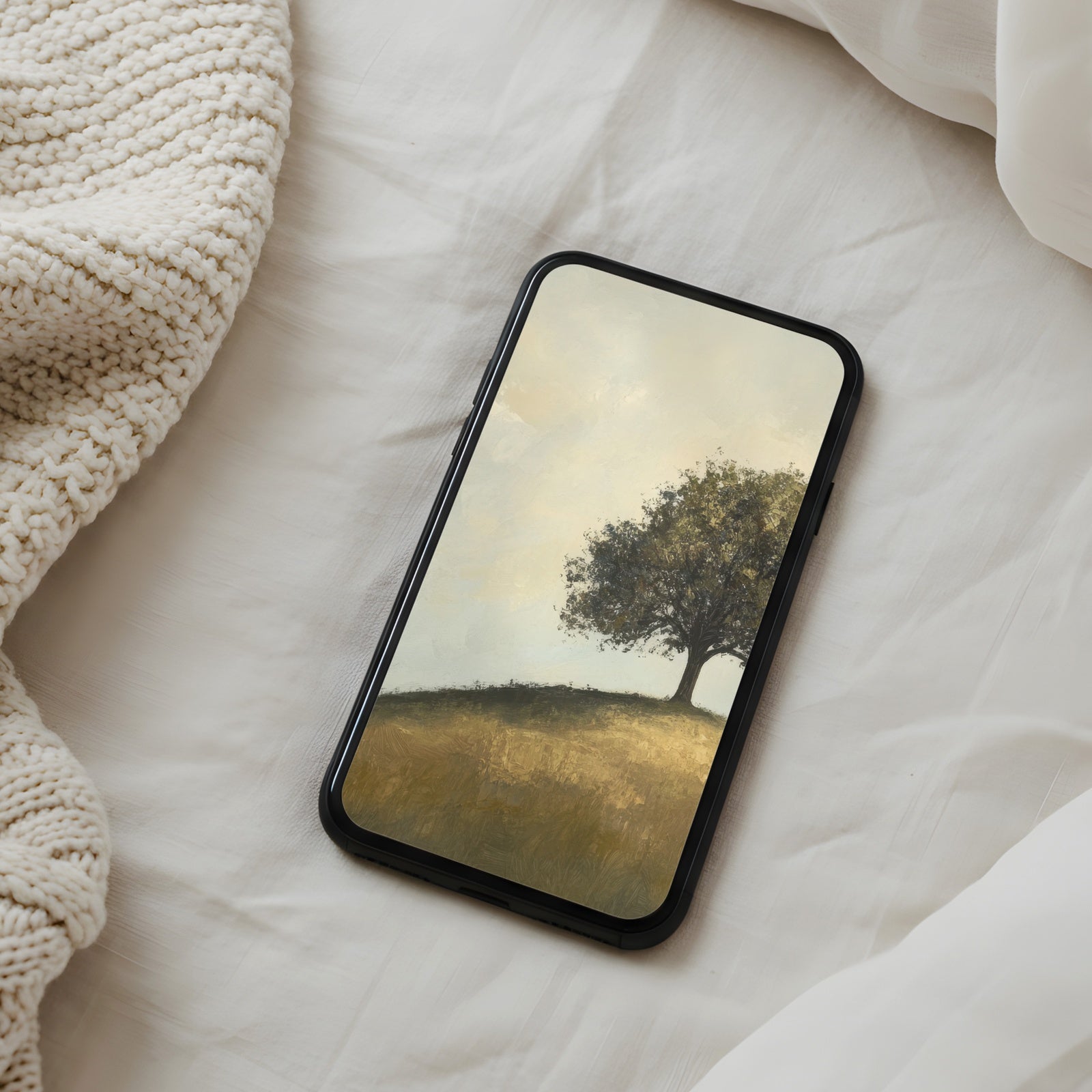 Peaceful phone wallpaper featuring a lone tree on a sunlit hill in soft golden tones, creating a calm, warm, and nature-inspired atmosphere