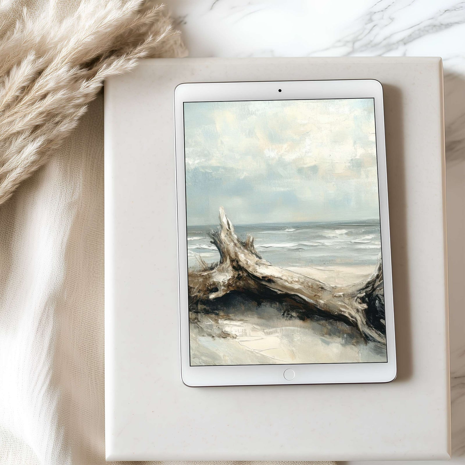 Coastal iPad wallpaper with driftwood on a serene beach, soft neutral tones and gentle waves creating a calm, minimalist tablet background perfect for a modern coastal aesthetic
