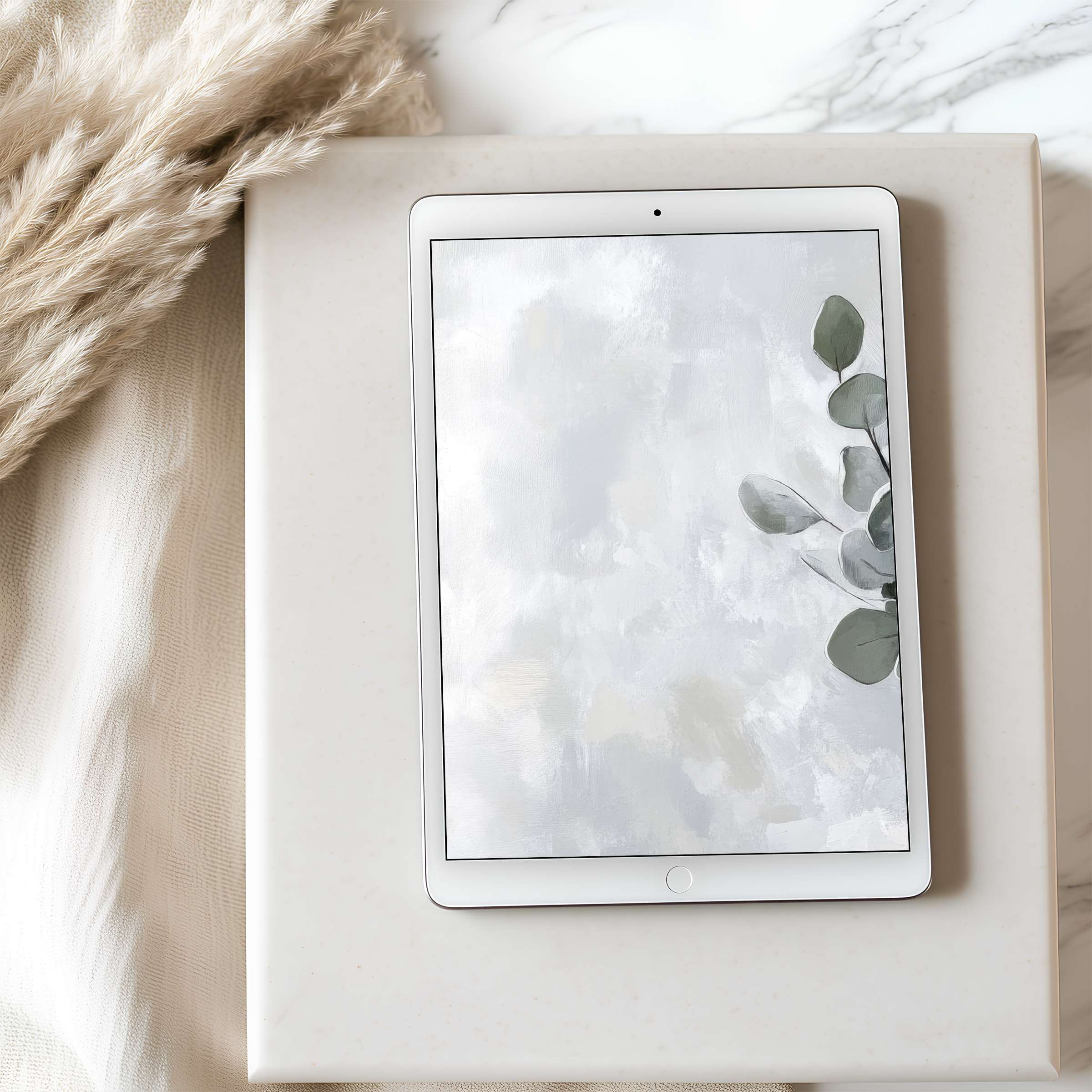 Organic-inspired tablet wallpaper featuring serene eucalyptus leaves in muted tones on iPad, perfect for stylish digital download
