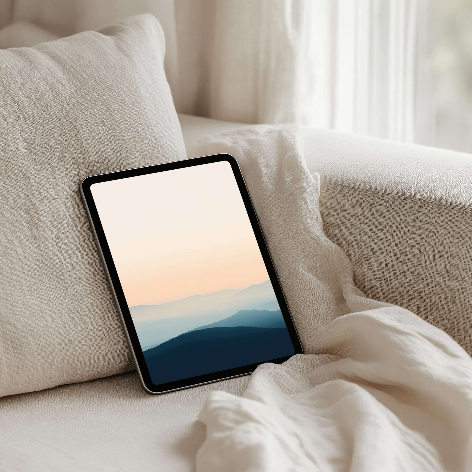 Modern iPad wallpaper with soft gradient tones fading over minimalist mountain silhouettes, calm and elegant tablet background that adds sophistication and serenity to your digital space