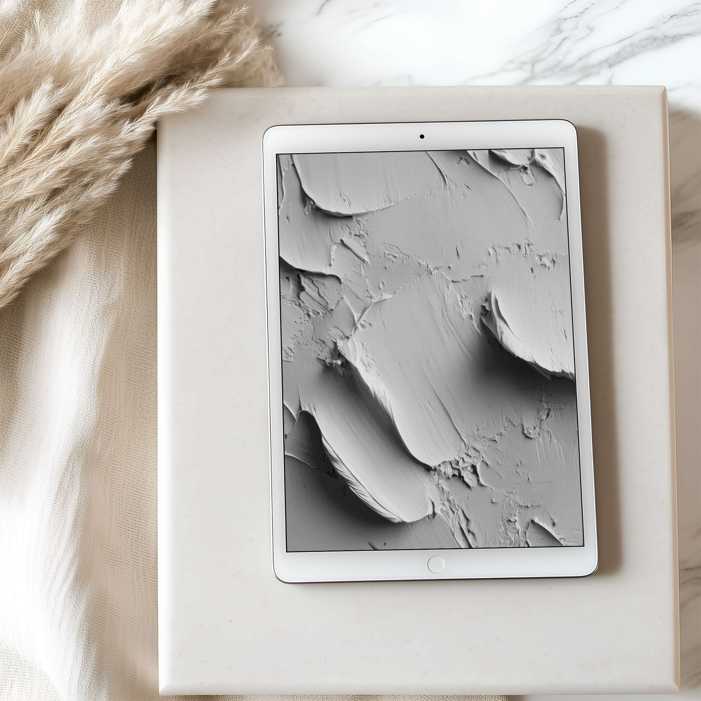 Elegant monochrome abstract tablet wallpaper with textured brush strokes displayed on an iPad amidst calm, sustainable decor settings